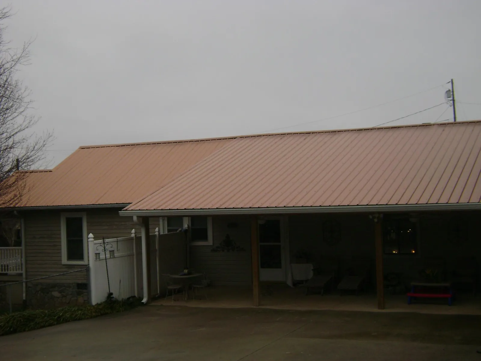 Copper toned metal roof over a wide covered patio in Toledo